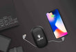 Power bank with a light up logo charging a mobile phone 